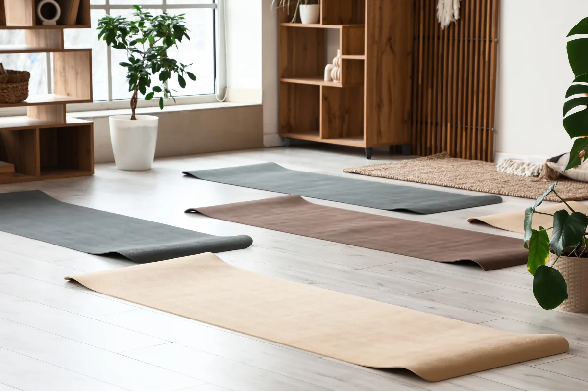 Heller Yogaraum mit ausgerollten Matten, Holzregalen und Zimmerpflanzen
